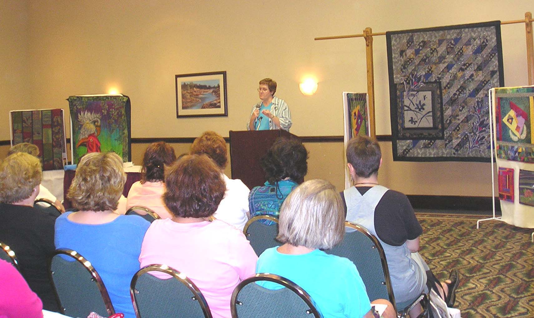 Photo of Dottie Gantt speaking at the Charlotte Quilter's Guild